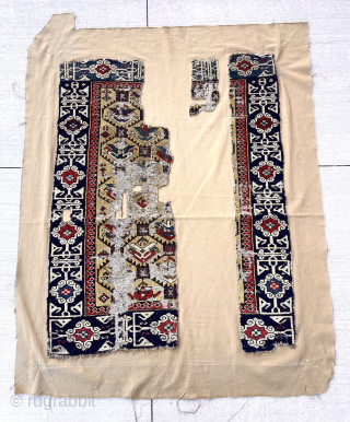 Out of the cedar chests. Early yellow ground Caucasian rug fragment. Sewn onto backing cloth. Saturated colors. Fine Kufic border. Good age. First half 19th c. Largest section 18” x 43”  