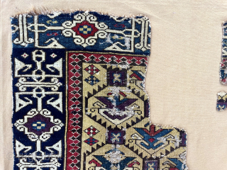 Out of the cedar chests. Early yellow ground Caucasian rug fragment. Sewn onto backing cloth. Saturated colors. Fine Kufic border. Good age. First half 19th c. Largest section 18” x 43”  