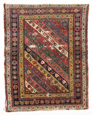 early little caucasian rug with some unusual design elements and splendid color. High quality wool with all natural colors featuring multiple reds, deep greens, fine old purples and beautiful yellow highlights. Never  ...