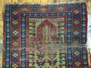 Wayne Barron 
Antique yellow ground Kazak prayer rug. Interesting design. As found, very dirty with wear and damage as shown. All natural colors.  Dated? 19th c. 3'2" x 4'9"
   
