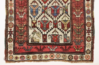 large antique ivory ground tribal persian rug with a great large scale palmette design. Rainbow colored main border. Possibly Luri? Beautiful natural colors including a fine old purple. Overall good condition with  ...