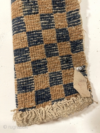 Interesting early Tibetan pile weaving in the classic checkerboard design. Complete little weaving with original selvages. Unclear what this was this long narrow weaving was made for or if this is a  ...