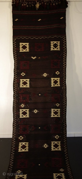 C143. Rare Muqori runner. The Muqori are a nomadic Pashtu-speaking group from southern Afghanistan. The field of this slit-weave kilim runner is a mixture of grey, brown and black wools that have  ...