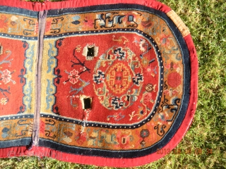 Tibetan Under Saddle Rug 49"x26.5".  More desirable oval shape with some signs of use. 1930s with cotton warps and wefts.  Typical colors for time period with great design.   