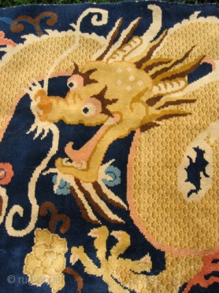 Chinese dragon rug (#857) 3’ 7” x 8’ 1”; large gold dragon in clouds on indigo field, excellent condition, 20th century.            