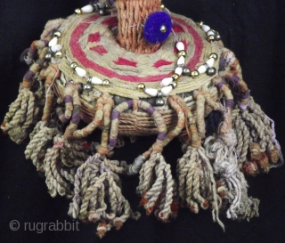 Decorative rope camel trapping, this vintage piece is embellished with shells, mirrors and tassels with a large central fringed rope pom pom.
This would be worn by placing over the head and neck  ...