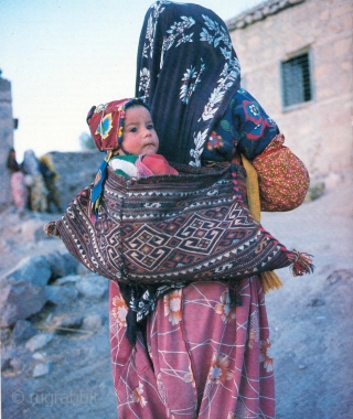 East Anatolian Shavak baby carrier, complete with kilim back.

Finely woven on a narrow hand loom in two joined soumac panels. Circa 1900 in original, unrepaired condition. Size 75x36cm. One of three Shavak  ...