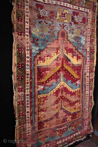  SOLD 19th century prayer rug from from Mucur in Kırşehir province, Central Anatolia.

An unusual mihrab with multiple arches, very good drawing and beautiful colours. Complete but worn with foundation showing, holes  ...