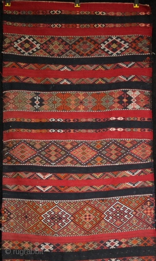 An old Anatolian long kilim runner, tightly woven flat weave with very fine çiçim and soumak embroidery, I estimate from the 1920s. Excellent drawing, good colours and in very good condition. 285x84cm

For  ...