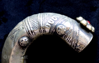 One of a collection of antique silver late 18th to early 20th century silver and silver alloy bracelets. Well executed hand hammered and stamped/chased tribal decoration and added ornamental pieces with glass  ...