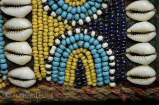 A pair of related but different antique tribal camel neck decorated bands. 

The bands incorporate a variety of materials and construction techniques. They are made using cowrie shells, hand made glass beads  ...