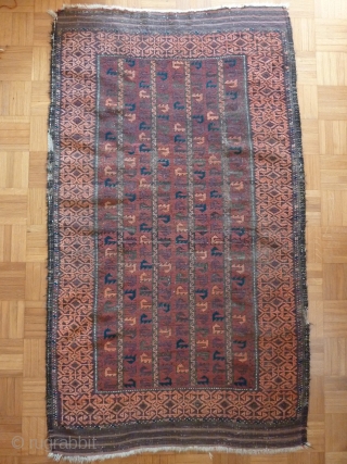 Old Baluch rug of a rare type. 
Complete with skirts. Damages to the selvedges and some wear in the field. Extraordinary complex border and appealing field including some aubergine color.
144cm x 85cm

 