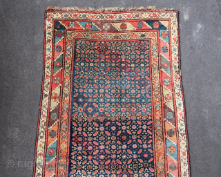 Old and colorful kurdish rug (119 cm. x 245 cm.)
A riot of colors, with good high pile almost everywhere.
In need of a good wash, few moth damages, slight localised wear on the  ...