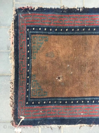 Tibetan rug, brown background with single group flower pattern, it was produced in Mid qing dynasty. Wool warp and weft. Size 75*150cm(29*58”)           