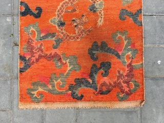 Tibetan rug, Orange background with bat pattern, surrounded by the bat veins. Very nice rug, good age and condition. Size 88*60cm(34*23”)            