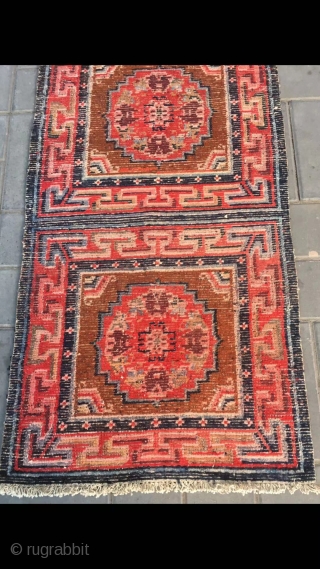 Tibetan rug, re color and three joined with single group flower pattern. Wool warp and weft. Late Qing Dynasty. Good and condition. Size 68*190cm(27*74”)         