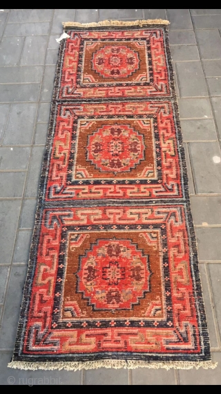 Tibetan rug, re color and three joined with single group flower pattern. Wool warp and weft. Late Qing Dynasty. Good and condition. Size 68*190cm(27*74”)         