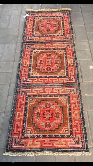 Tibetan rug, re color and three joined with single group flower pattern. Wool warp and weft. Late Qing Dynasty. Good and condition. Size 68*190cm(27*74”)         
