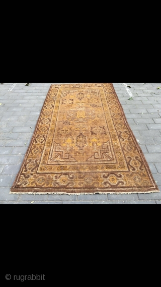 #2023 Xinjiang carpet. It was produced in Khotan area. Late 19th / circa 1900. Brown background with Xinjiang Khotan flowers pattern, some early synthetic color . Wool weft and cotton warp. Size  ...