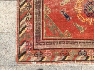 Khotan rug,  it was produced in Khotan area, red background with group flowers veins, lucky clouds sell. About 1920. It has a little wool pile worn. Size 135*245cm(53*96”)    