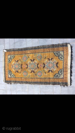 Tibetan rug, Yellow color with group flowers and lucky clouds  veins . about late Qing Dynasty. Good age. Size 80*160(31*62”)            