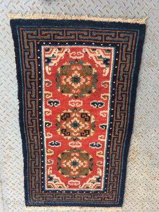 Tibet rug, red color, three medallions flower pattern around lucky cloud veins. good colors and condition, good age , 4 rows of knots rewoven at one end. Size 133*73cm(52*28")    