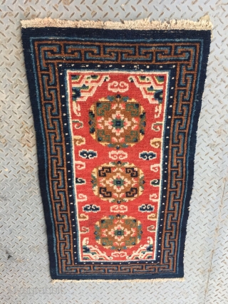 Tibet rug, red color, three medallions flower pattern around lucky cloud veins. good colors and condition, good age , 4 rows of knots rewoven at one end. Size 133*73cm(52*28")    