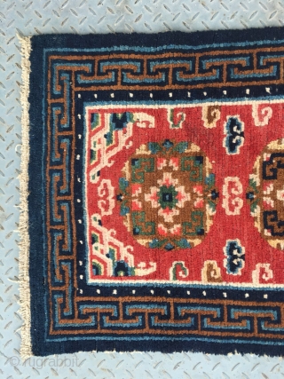 Tibet rug, red color, three medallions flower pattern around lucky cloud veins. good colors and condition, good age , 4 rows of knots rewoven at one end. Size 133*73cm(52*28")    