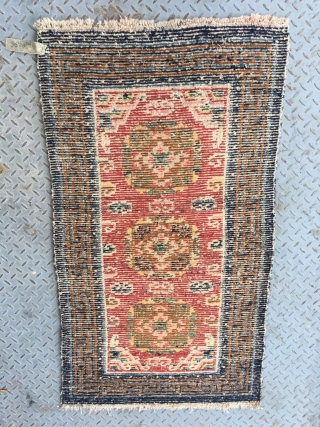 Tibet rug, red color, three medallions flower pattern around lucky cloud veins. good colors and condition, good age , 4 rows of knots rewoven at one end. Size 133*73cm(52*28")    