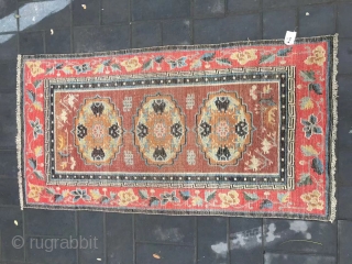 Tibet rug, camel background with three group flowers pattern, around red color full flower selvage. Size 152*83cm(59*32”) wool warp and weft. Good age          