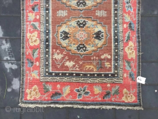 Tibet rug, camel background with three group flowers pattern, around red color full flower selvage. Size 152*83cm(59*32”) wool warp and weft. Good age          