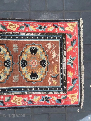 Tibet rug, camel background with three group flowers pattern, around red color full flower selvage. Size 152*83cm(59*32”) wool warp and weft. Good age          