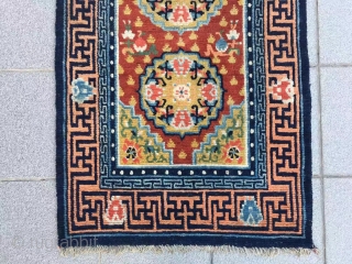 Tibet rug, red background with three group flower pattern, around with Buddha hand veins. Good age and condition. Size 148*72cm(58*28”)             