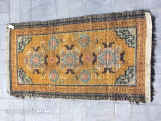 Tibet rug, yellow background with nice group flowers pattern, Lucky clouds  in the four corner. Good age and condition. Size 160*88cm(62*34”). Wool warp and weft       