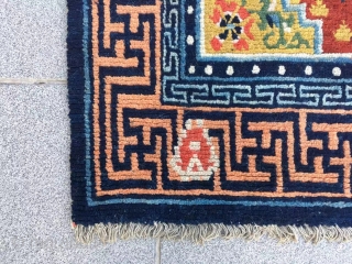 Tibet rug, red background with three group flower pattern, around with Buddha hand veins. Good age and condition. Size 148*72cm(58*28”)             