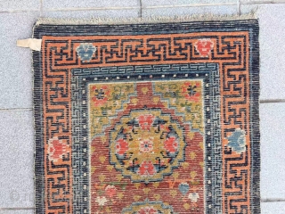 Tibet rug, red background with three group flower pattern, around with Buddha hand veins. Good age and condition. Size 148*72cm(58*28”)             