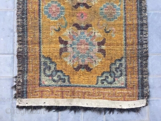 Tibet rug, yellow background with nice group flowers pattern, Lucky clouds  in the four corner. Good age and condition. Size 160*88cm(62*34”). Wool warp and weft       