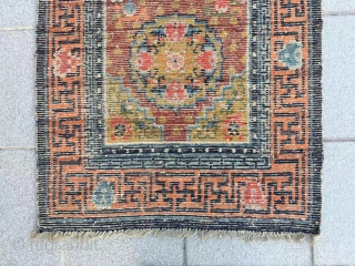 Tibet rug, red background with three group flower pattern, around with Buddha hand veins. Good age and condition. Size 148*72cm(58*28”)             