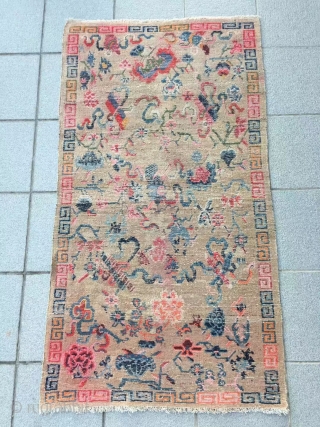 Tibet rug, light camel background with Buddha eight treasures pattern. Size 153*82cm(60*32”). Good age and condition.                 