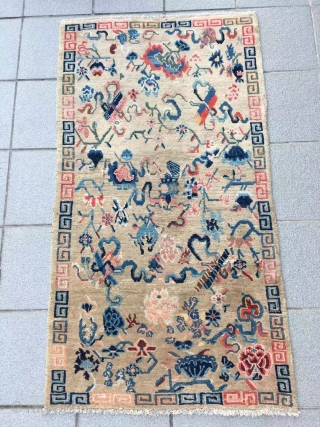 Tibet rug, light camel background with Buddha eight treasures pattern. Size 153*82cm(60*32”). Good age and condition.                 