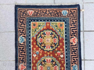 Tibet rug, red background with three group flower pattern, around with Buddha hand veins. Good age and condition. Size 148*72cm(58*28”)             