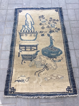 Chinese Baotou rug, light camel backs with antique Bogu veins, vase, Peony, Ruyi, bonsai as well as the text are allegorical spring, sunshine good luck. Good age and condition. Size 96*165cm(37*64”)  