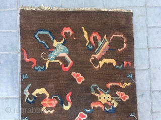 Tibetan rug, brown background with Buddha eight treasures pattern. Wool warp and weft. Good age and condition. Size 150*80cm
              