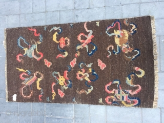 Tibetan rug, brown background with Buddha eight treasures pattern. Wool warp and weft. Good age and condition. Size 150*80cm
              