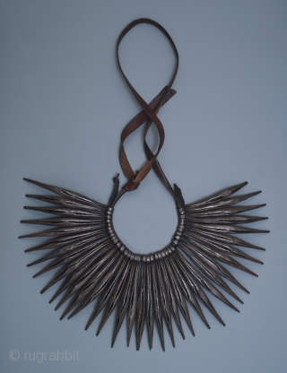 Pikuran, cache-sexe,
Kirdi peoples, Mandara Mountains, Cameroon.
Iron, leather
The row of spikes is 6.5" (16.5 cm) wide by 4.75" (12 cm) high
Early to mid-20th century
Worn by young women, the spikes on this cache-sexe curve  ...