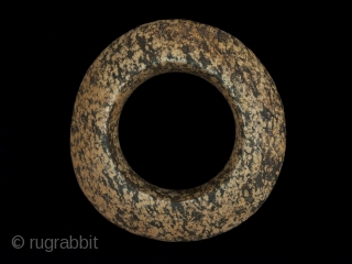 Stone Ring, Western Sahara, Africa.
4.25" (10.8 cm) diameter, 1" (2.5 cm) thick at center, 7" (18 cm) inner circumference, 315 grams
Neolithic Period, 2000 B.P. or earlier
No one really knows how these rings  ...