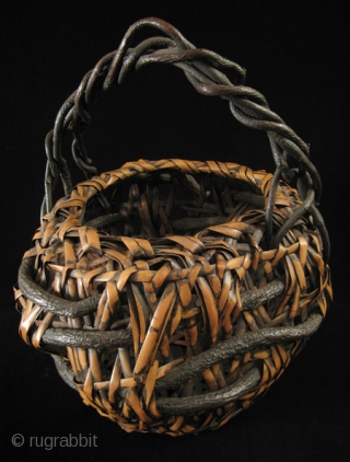 Ikebana basket, Japan.
Nemagaridake bamboo, vines.
12" wide by 15" high (30 by 38 cm).
Pre-1950.                    