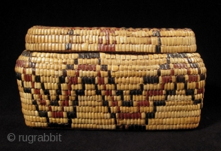 Fully imbricated lidded basket.
Native American, Columbia River.
Reeds, cedar bark.
9" wide by 3" high (23 by 7.5 cm).
Last quarter 19th century.             