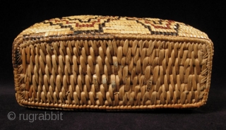 Fully imbricated lidded basket.
Native American, Columbia River.
Reeds, cedar bark.
9" wide by 3" high (23 by 7.5 cm).
Last quarter 19th century.             