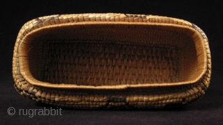 Fully imbricated lidded basket.
Native American, Columbia River.
Reeds, cedar bark.
9" wide by 3" high (23 by 7.5 cm).
Last quarter 19th century.             